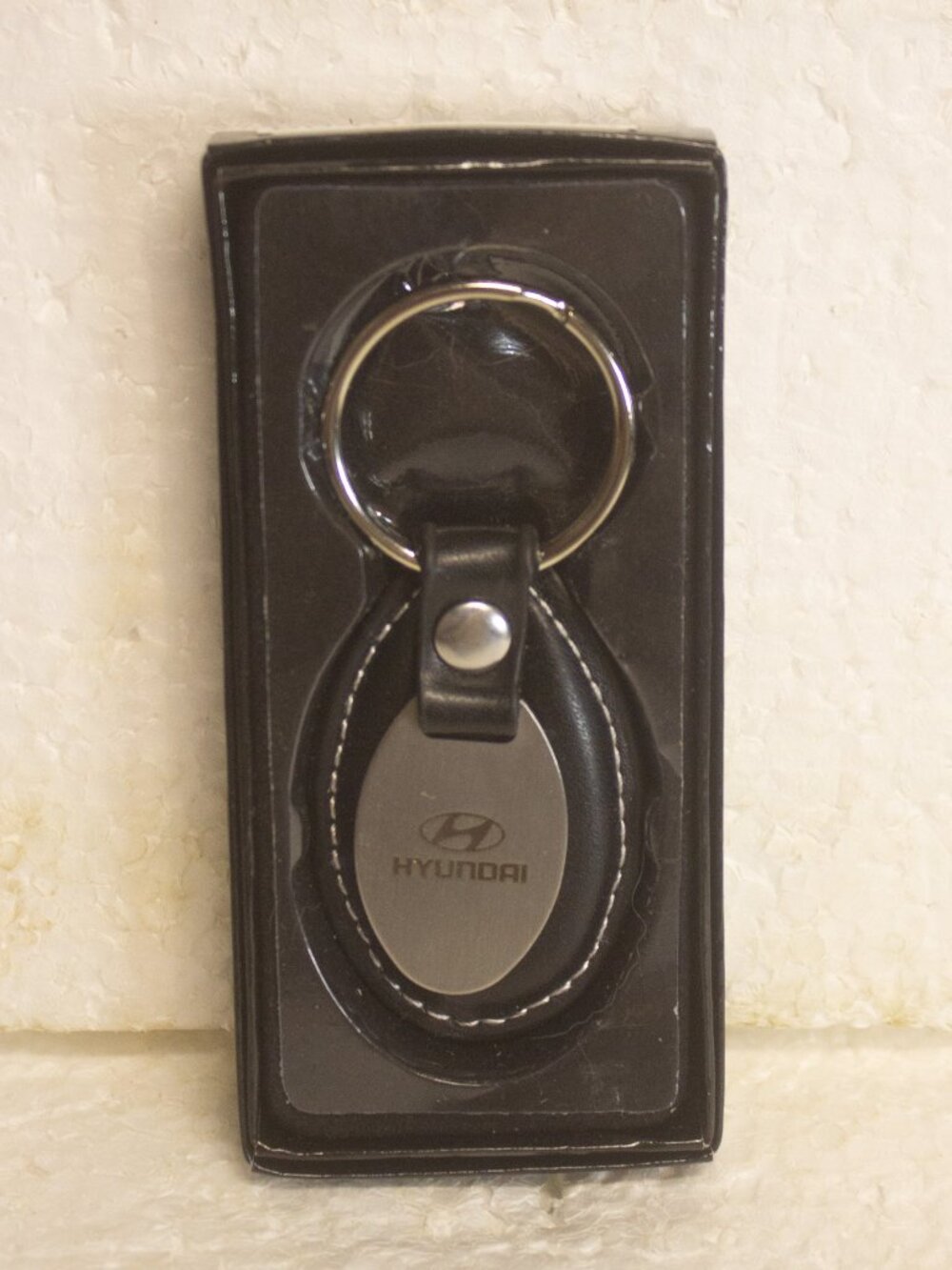 Hyundai Genuine Parts Keyring Leather Oval with Oval Metal Plaque on front.